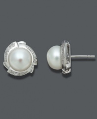 Polished to perfection. Always classy, these stunning studs highlight cultured freshwater pearls (9-10 mm) surrounded by a diamond-accented petal design set in sterling silver. Approximate diameter: 1/2 inch.