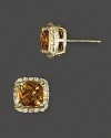 Diamonds frame faceted citrine, set in 14K yellow gold.