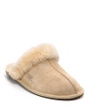 You'll never want to take off these cozy suede slippers with a genuine shearling cuff and lining from UGG® Australia.
