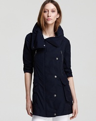 Perfect for the minimalist at heart, this Burberry Brit jacket features an easy A-line silhouette and classic hardware. A roll-up hood tucks into the collar for a utilitarian-chic finish.