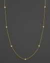 Diamond stations punctuate a long, elegant 18K yellow gold chain. By Roberto Coin.