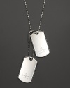 From the Dogtag Collection, a sterling silver bead necklace with engraved logo dog tag charms. Designed by Gucci.