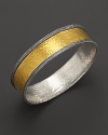 Intricately textured sterling silver frames a bold, gleaming band of 24K. yellow gold. By Gurhan.