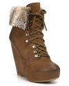 Faux fur lining softens these rugged lace-up booties for sky-high chic when temperatures fall. By Boutique 9.