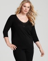 A basic Eileen Fisher silk top is lent subtle glamour with a scattering of tonal beads and sequins at the neckline.