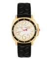 A little old-fashioned and a little over-the-top. Watch by Betsey Johnson crafted of black quilted leather strap and round polished gold tone mixed metal case with black bezel. White dial features whimsical gold tone numerals, gold tone hour and minute hands, pink second hand with heart and logo. Quartz movement. Water resistant to 30 meters. Two-year limited warranty.
