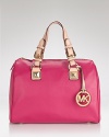 Add an injection of color to your accessories arsenal with this bold pink satchel from MICHAEL Michael Kors. The candy colored bag looks deliciously chic over a simple trench coat.