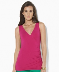 The figure-flattering petite top from Lauren by Ralph Lauren is crafted with ruching at the waist to create a faux-wrap silhouette. (Clearance)