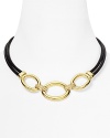 T Tahari makes a mixed material statement with this gold-plate and leather necklace, boasting a bold contrast of tone and texture.
