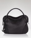 A sleek, chic leather hobo with contemporary panel details and a clever lockable top zip. By Salvatore Ferragamo.