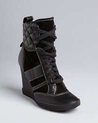 Chloé puts its hallmark, statement-making style on the must-have wedge sneaker, that takes the high top to high fashion.