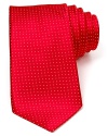 A wide silk tie embellished with a tonal pindot print.